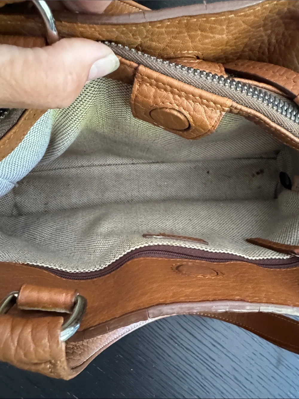 Dooney & Bourke tan pebbled leather side pockets belted satchel bag.